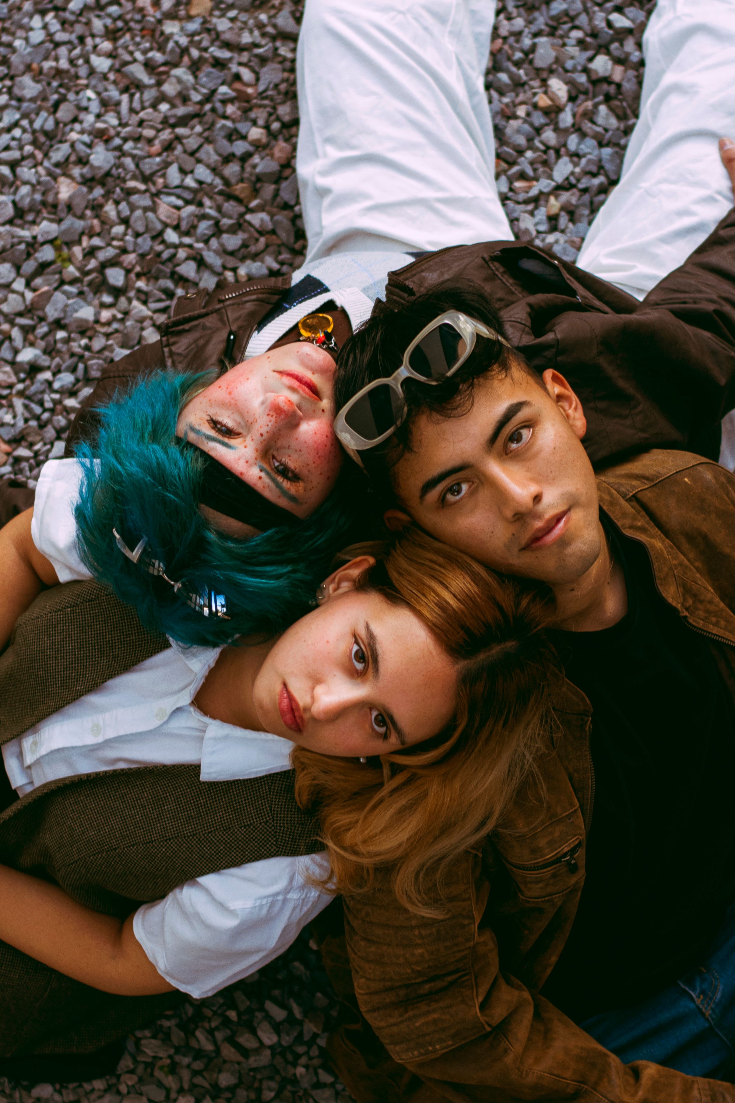 Top Down View of Three Young Friends Relaxing Outdoors · Free Stock Photo