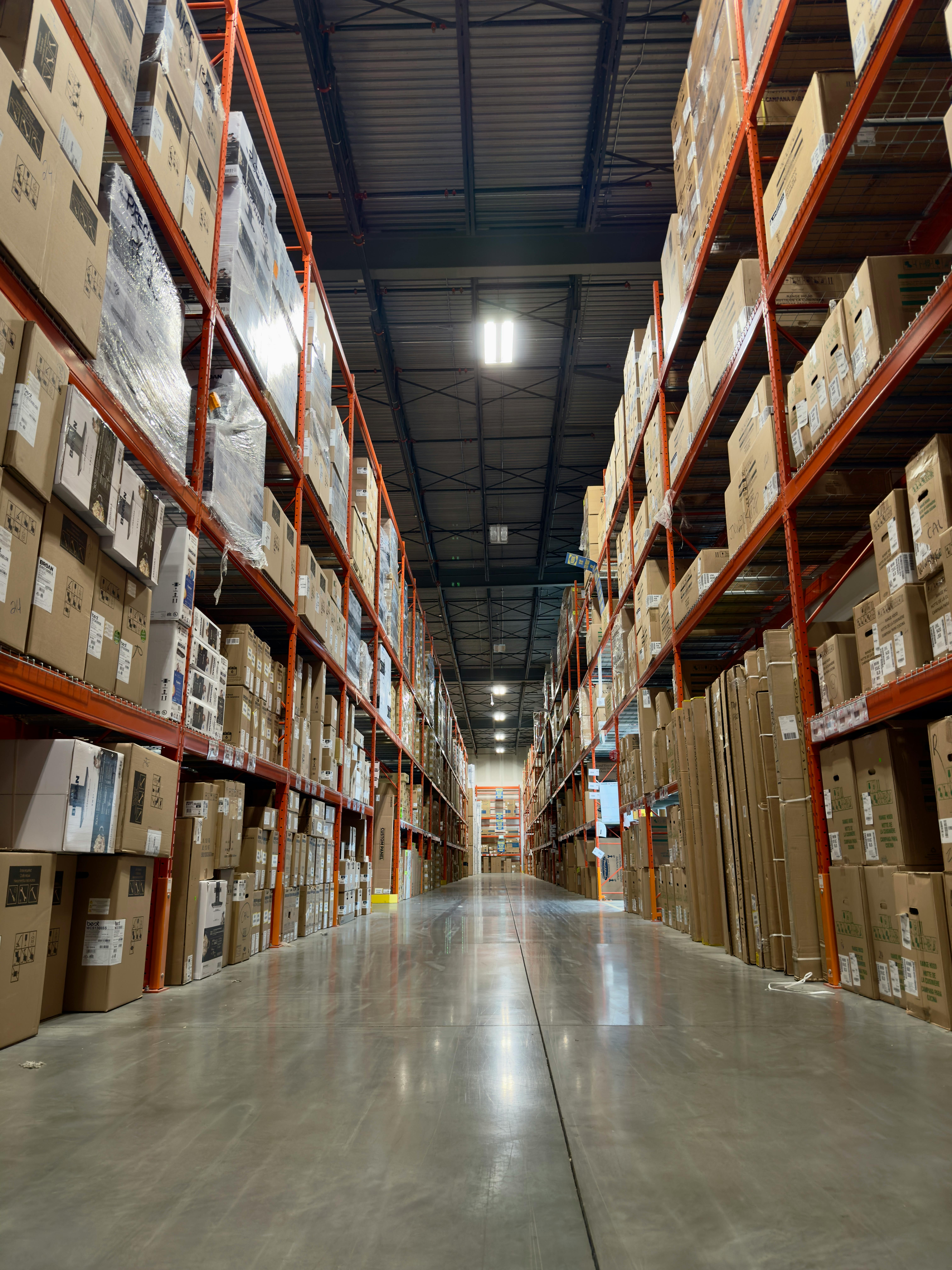 An image of a clean distribution center with aisles filled with boxes