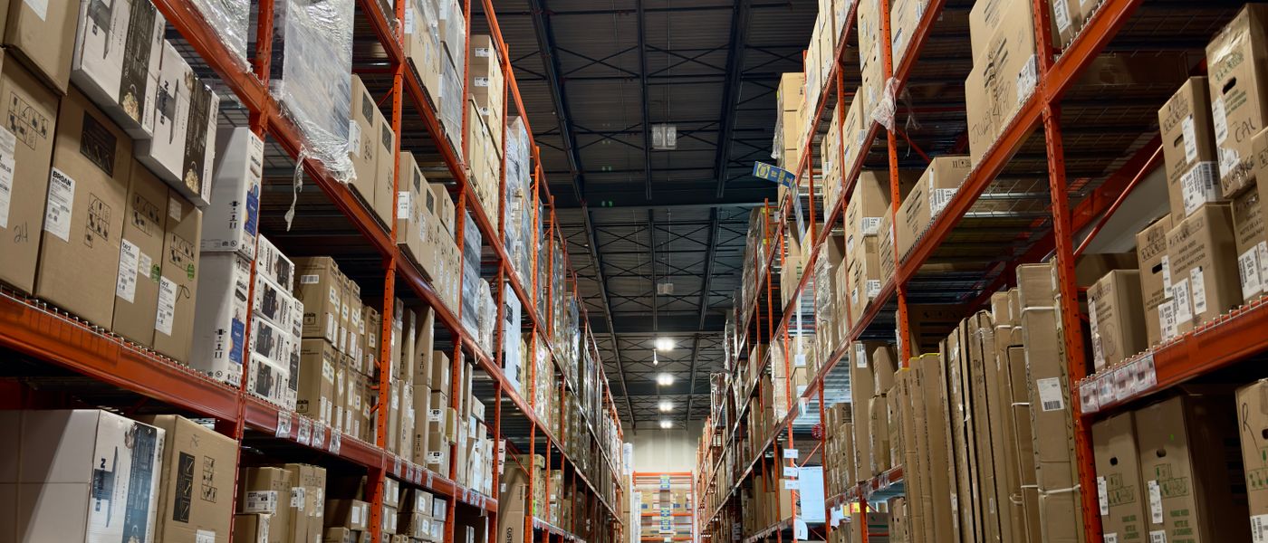 Expansive warehouse aisle filled with pallets and products