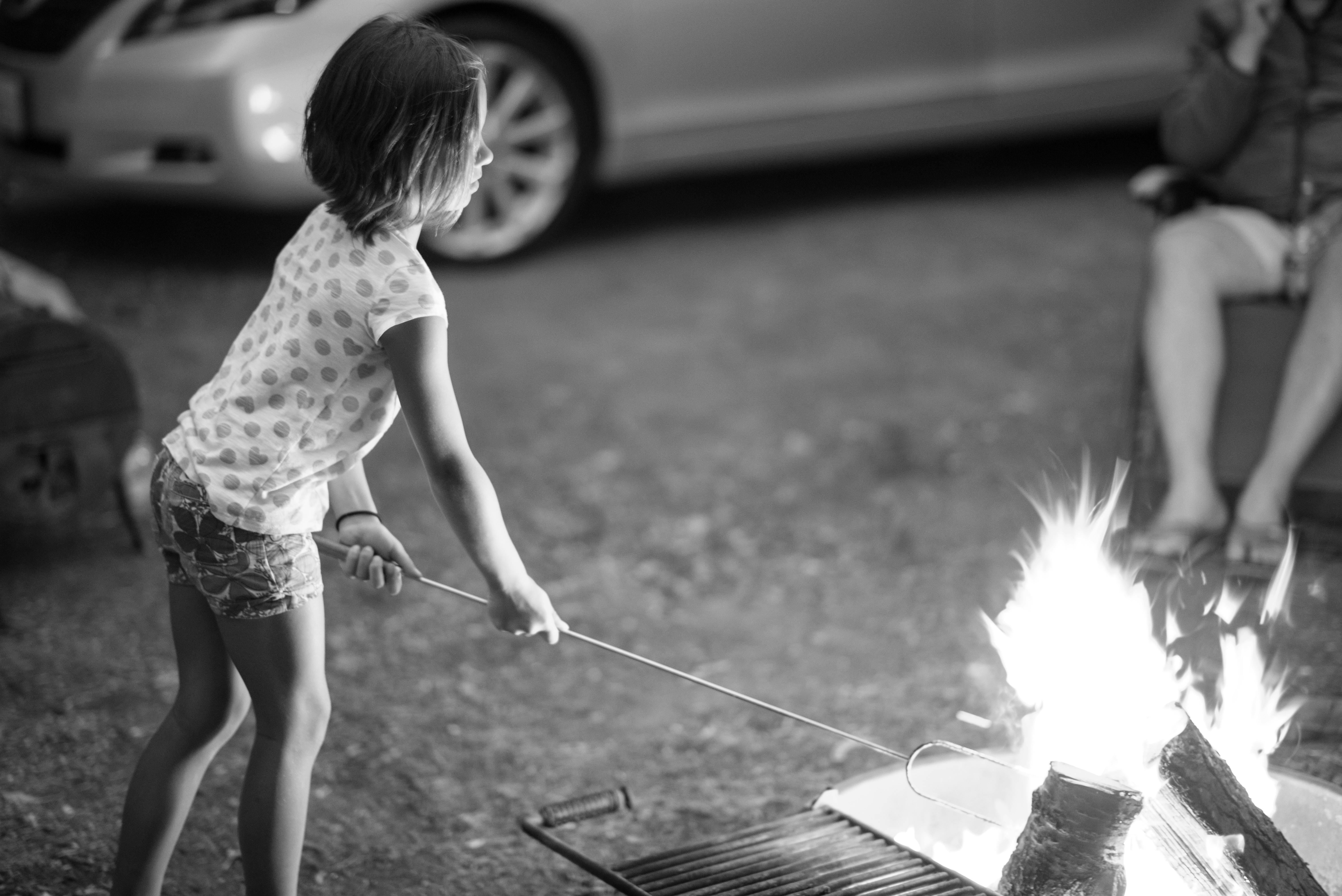 Child Roasting Marshmallows Over Campfire · Free Stock Photo