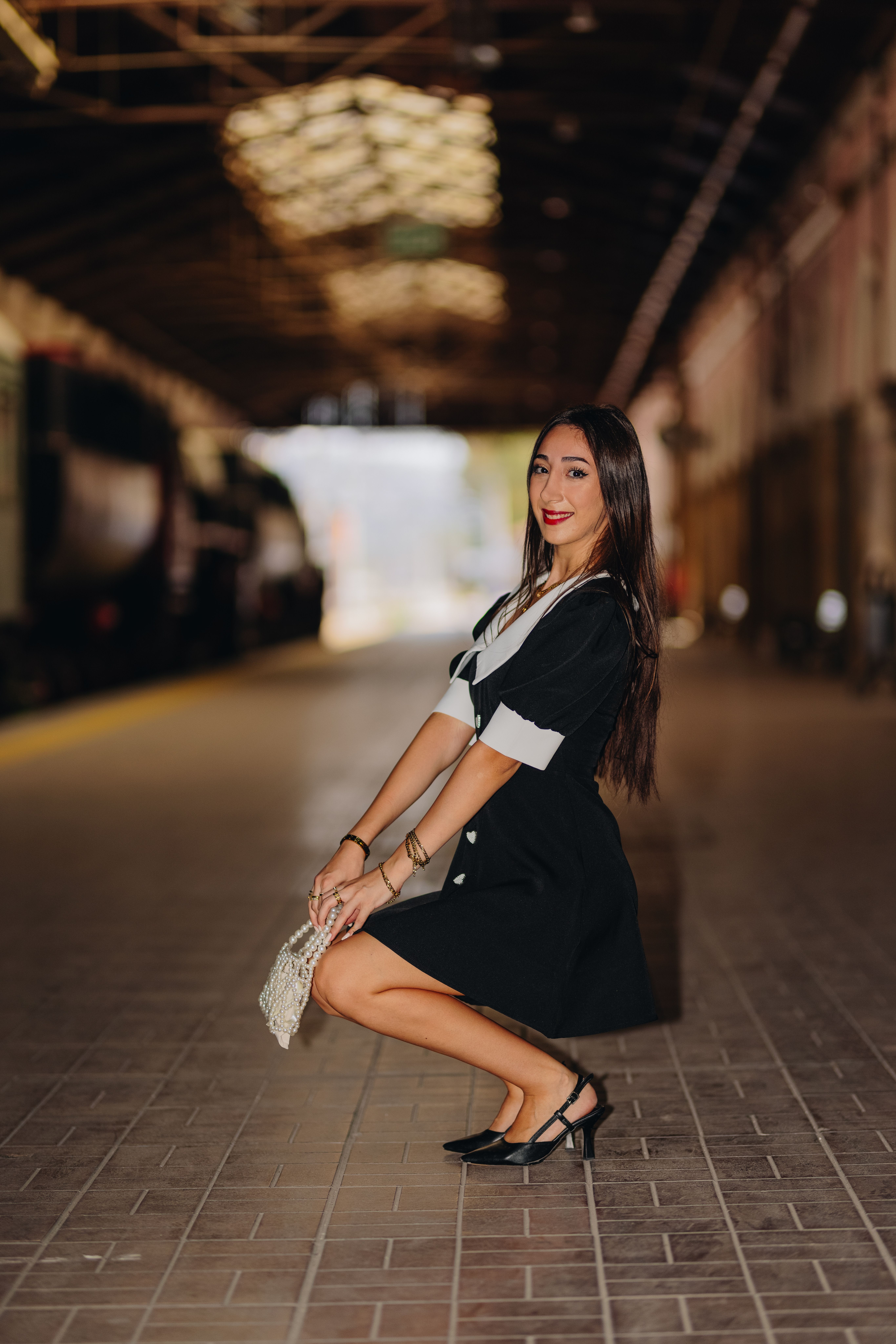 Young Woman in Black Dress at a Train Station · Free Stock Photo