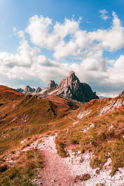 Free Majestic mountain landscape with trail in the Dolomites under a bright blue sky. Stock Photo