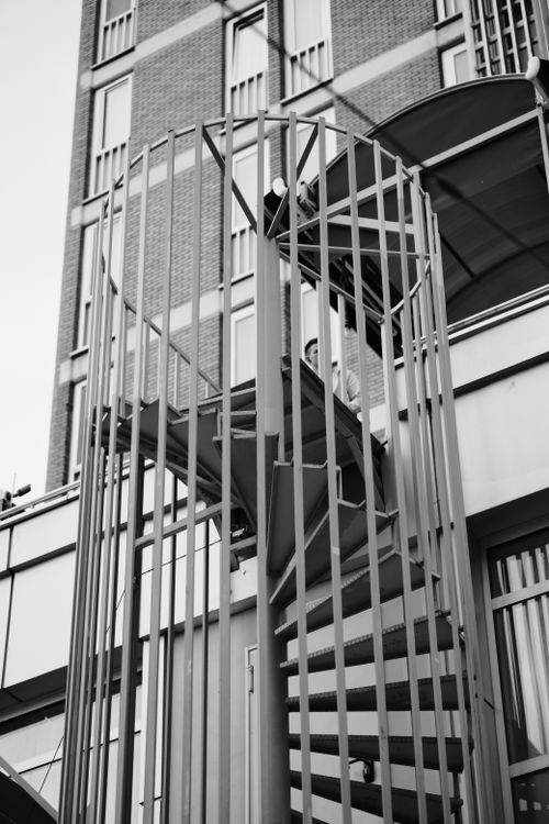Free Monochrome image of an outdoor spiral staircase with modern architectural elements. Stock Photo