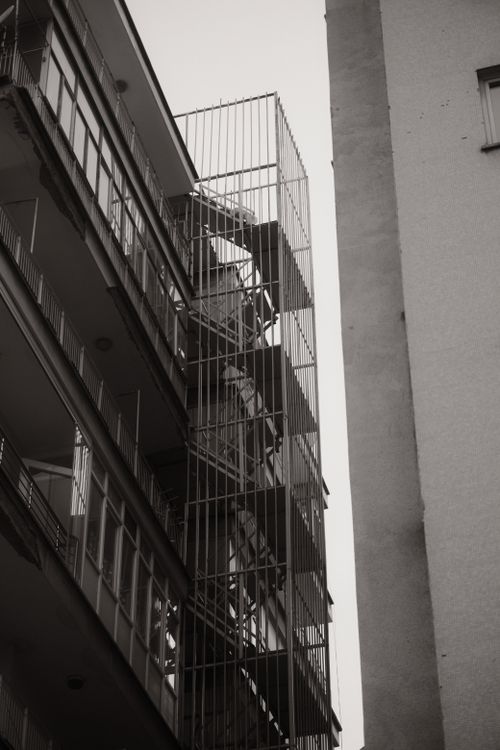 Free Monochrome view of a fire escape in an urban setting, emphasizing geometric lines. Stock Photo