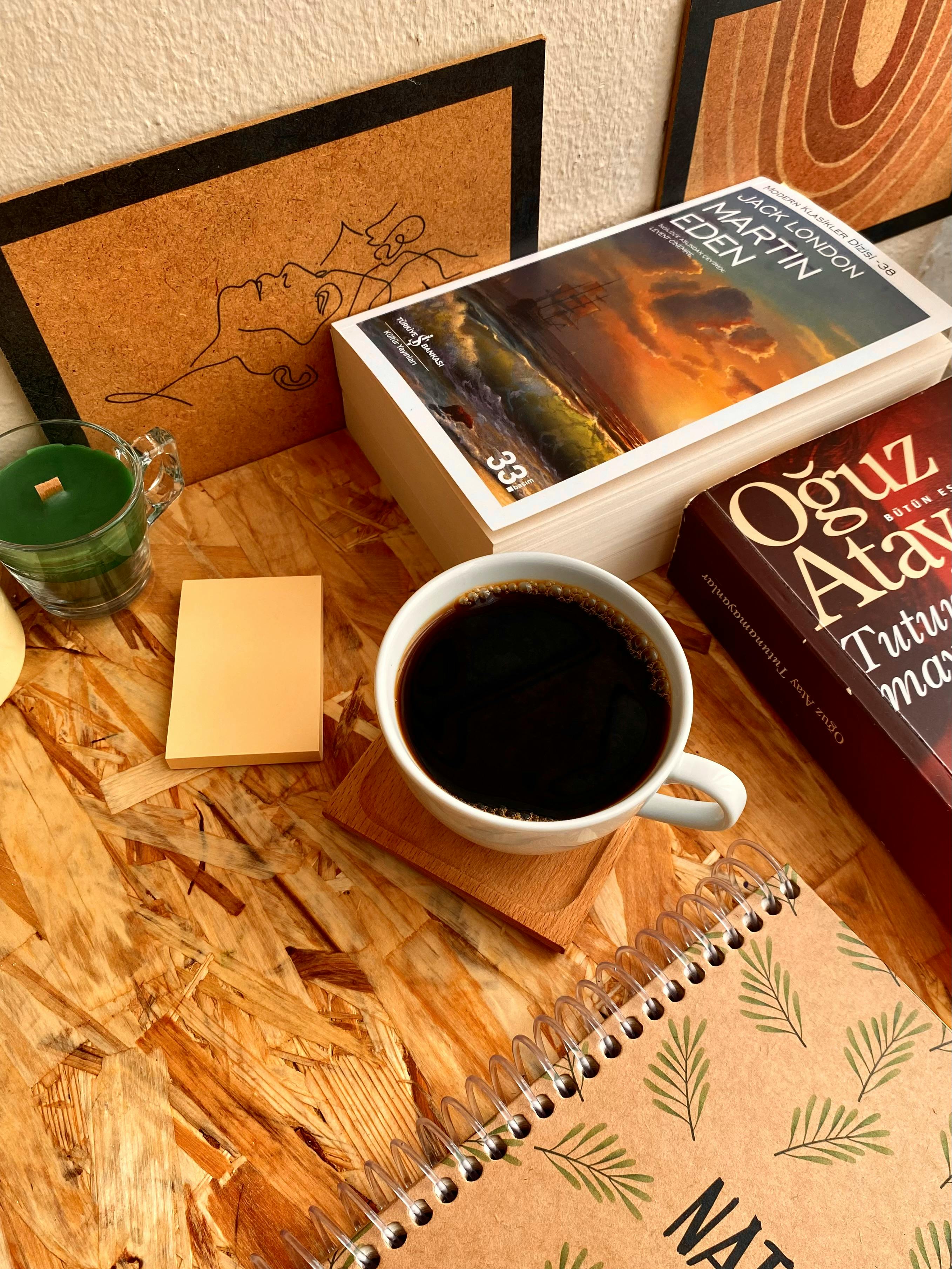 Comfortable workspace with books, coffee, and relaxing decor.