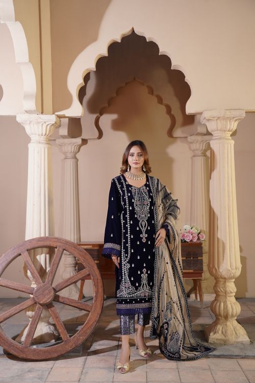 Free Woman wearing traditional attire poses elegantly in an architectural setting. Stock Photo