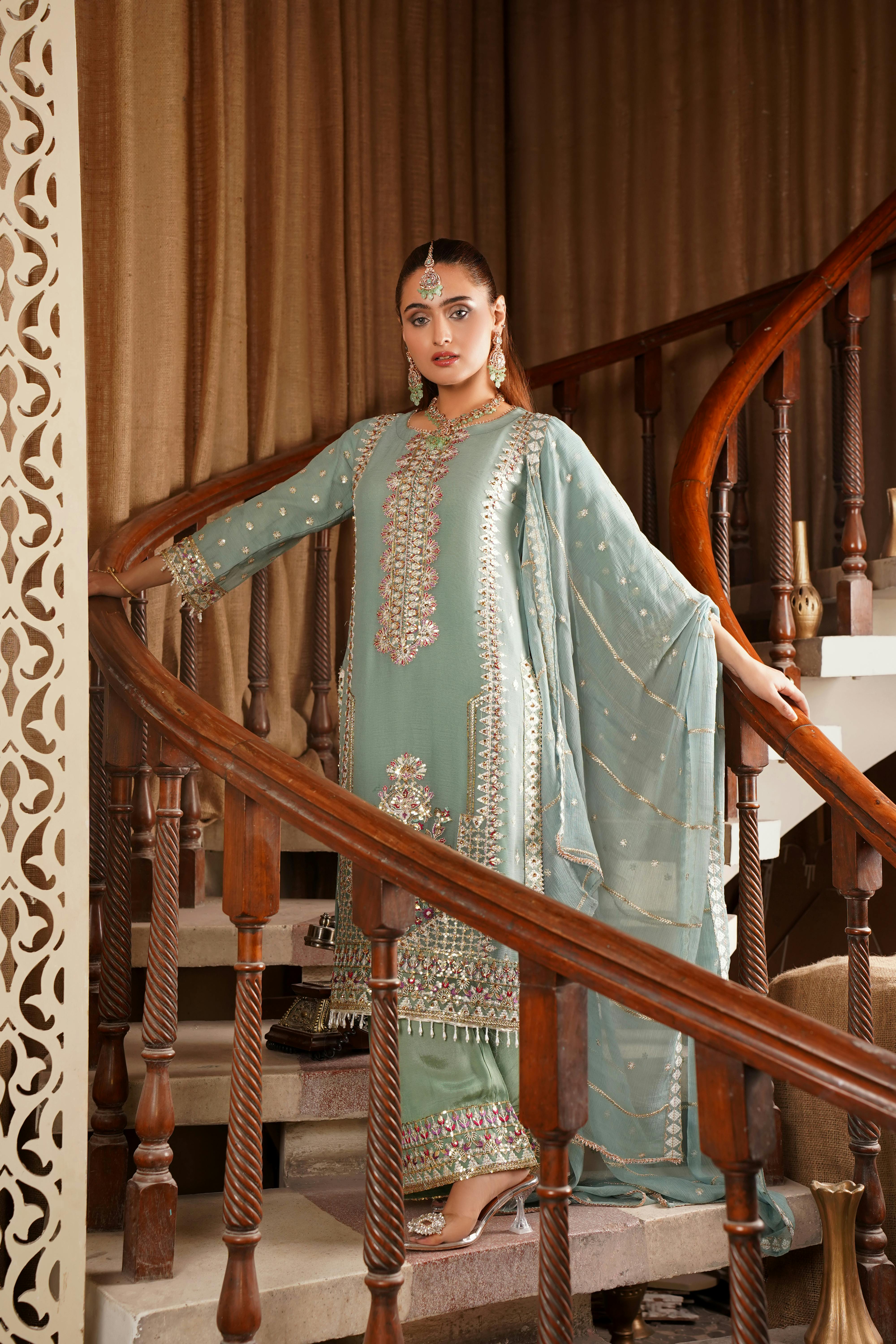 An elegant bridal portrait featuring intricate traditional attire on a staircase in Lahore.