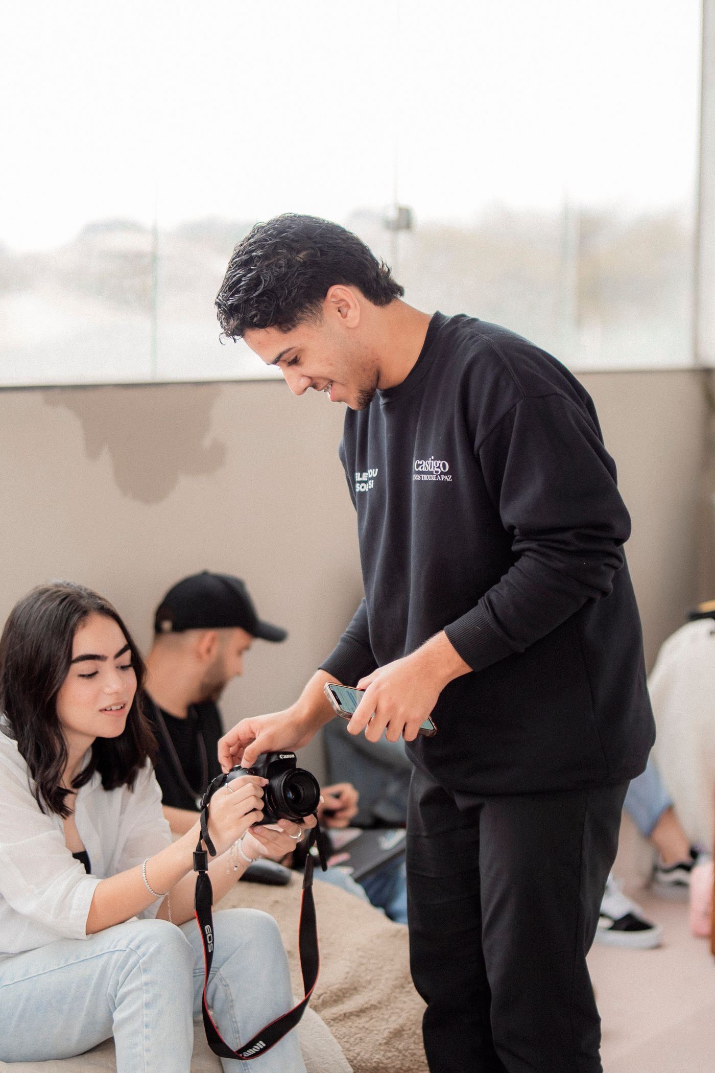 Young adults learning camera work in a hands-on workshop