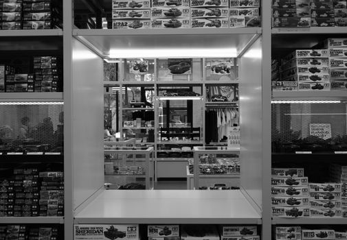 Interior view of a model kit store showing shelves filled with boxes of model kits.
