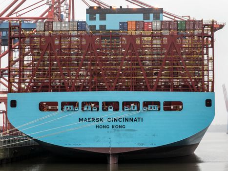 Close-up of a container ship docked at Hamburg's bustling port for cargo handling.