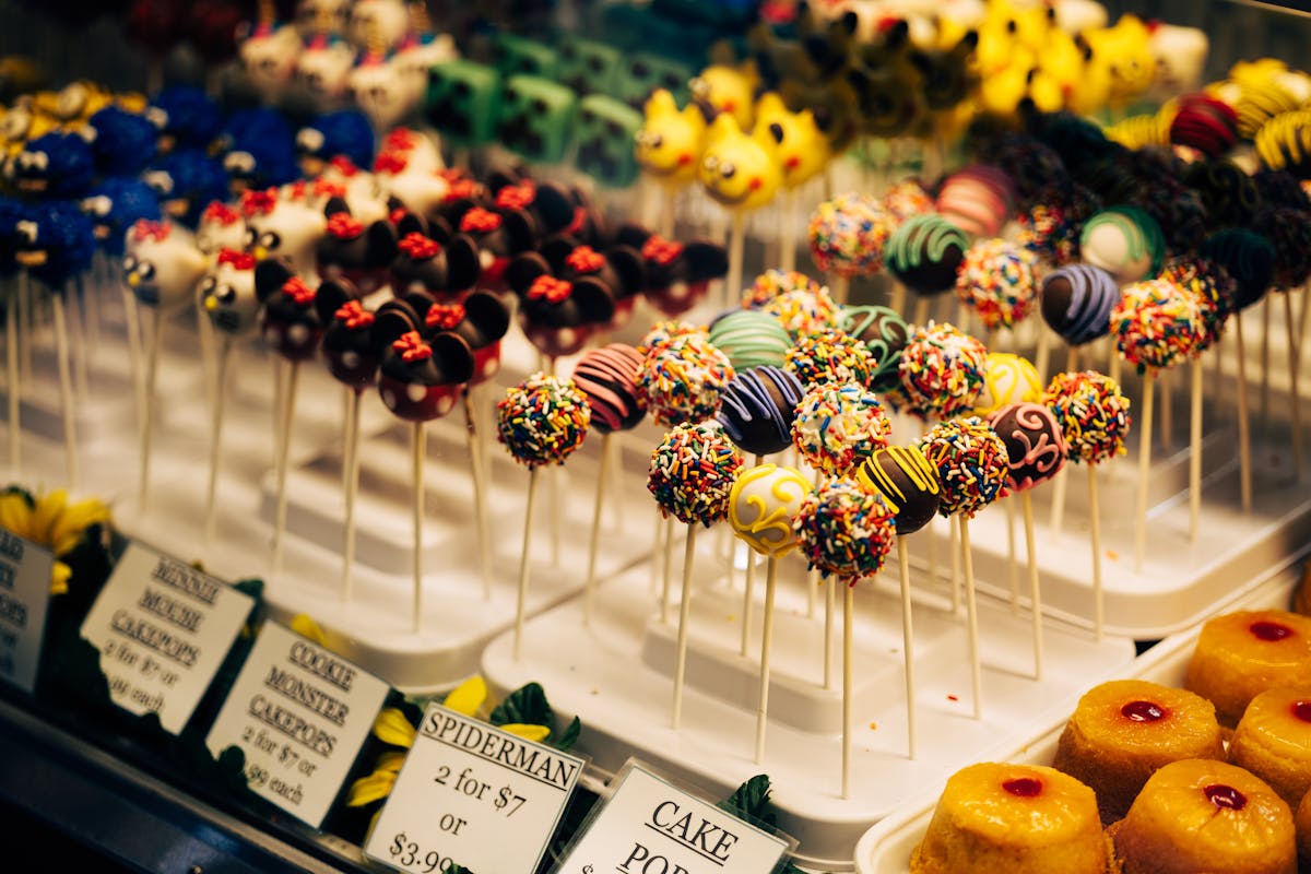 Colorful cake pops displayed in a bakery case