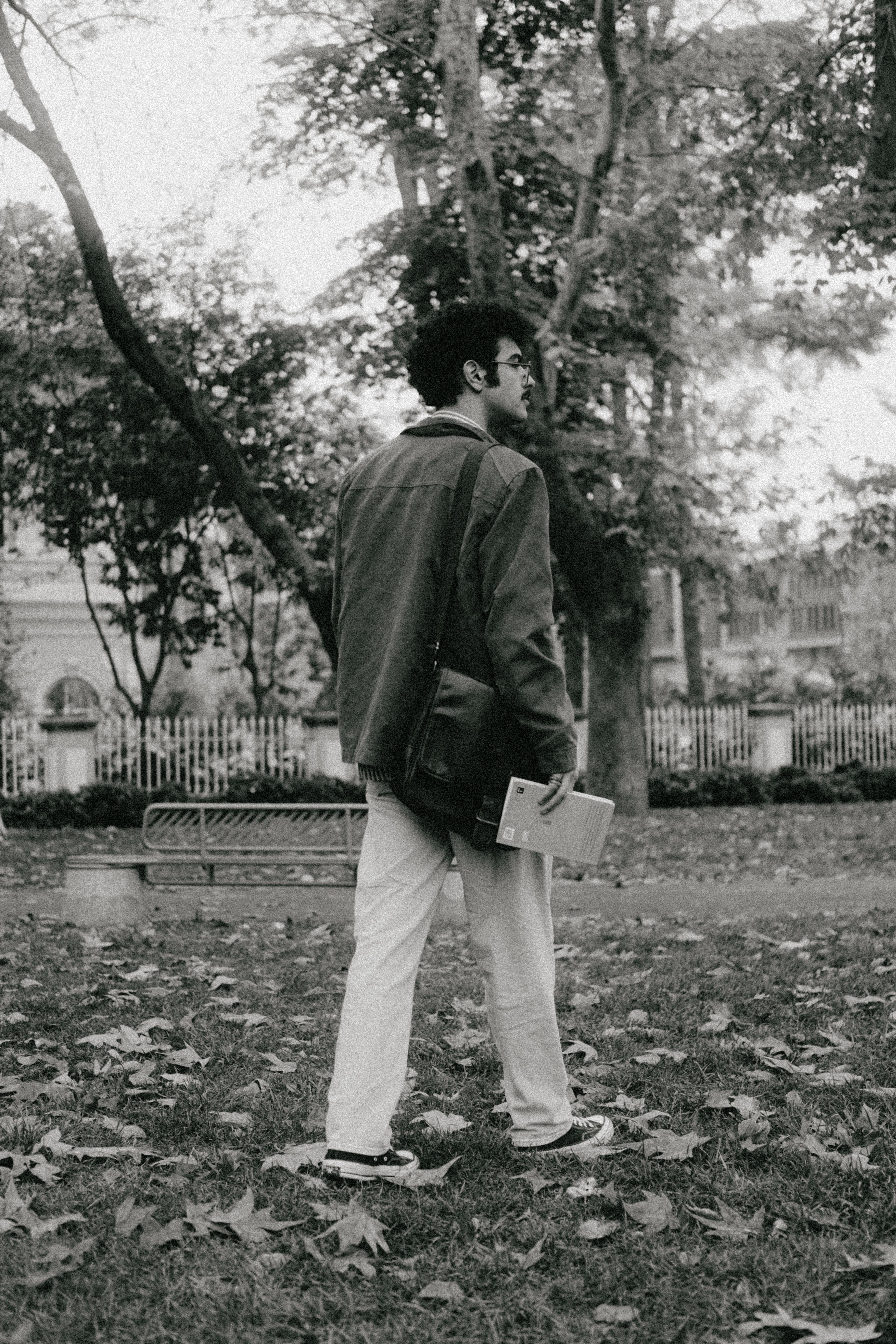 Young Man Strolling Through Park in Autumn