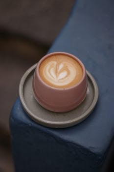 Stylish latte art in a pink cup, perfect for coffee lovers.