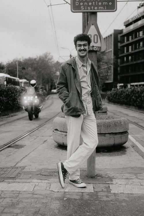 Free Black and white photo of a man posing in a city street with vintage vibes. Stock Photo