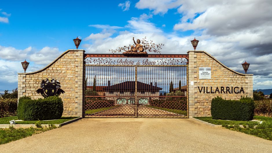 Explore the scenic entrance to VILLARRICA Vineyard, showcasing its unique architectural design.