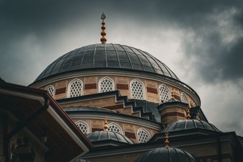 Free Captivating view of a mosque dome in Turkey against a moody sky, showcasing Islamic architecture. Stock Photo