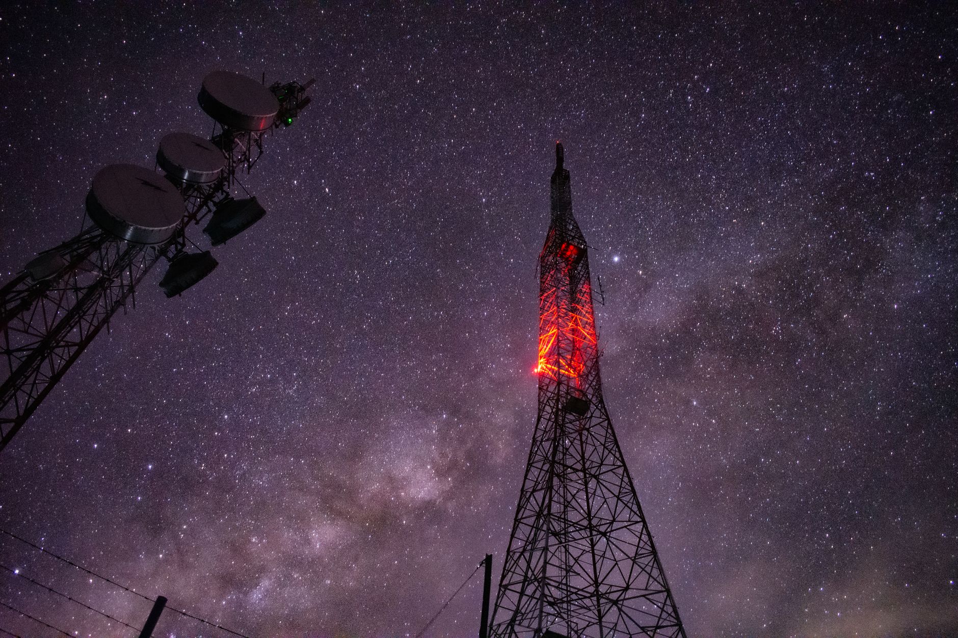 Stunning capture of a communication tower under a star-filled night sky.
