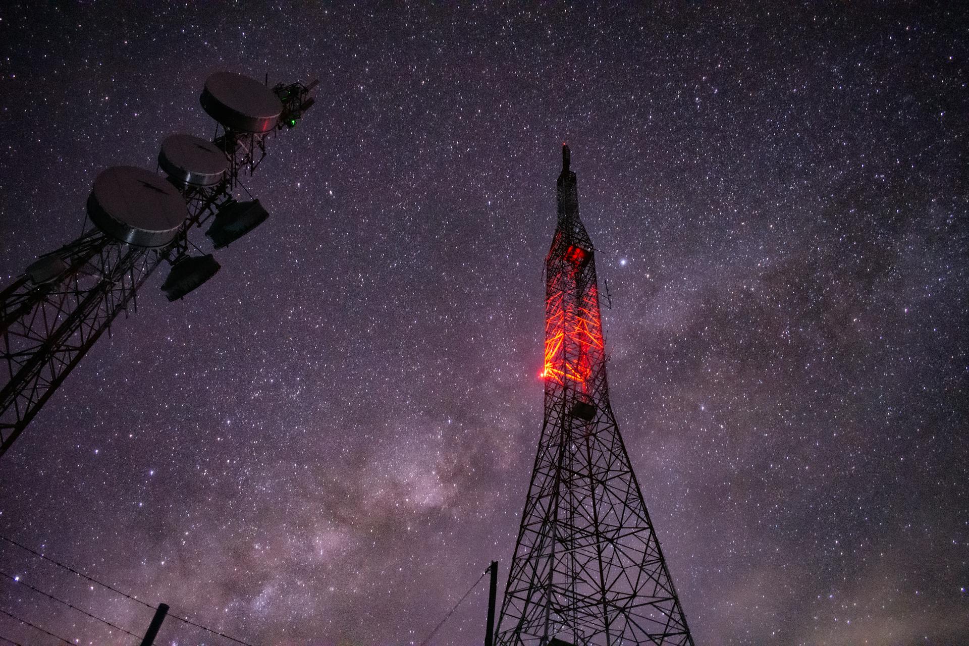 Stunning capture of a communication tower under a star-filled night sky.