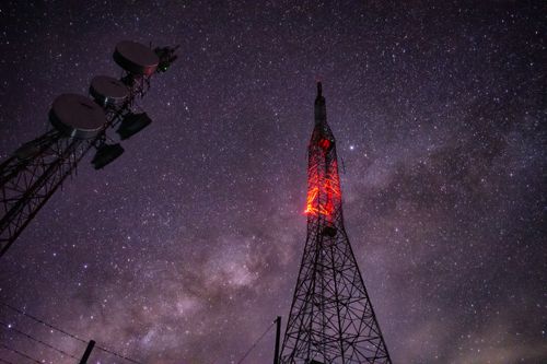 Free Stunning capture of a communication tower under a star-filled night sky. Stock Photo