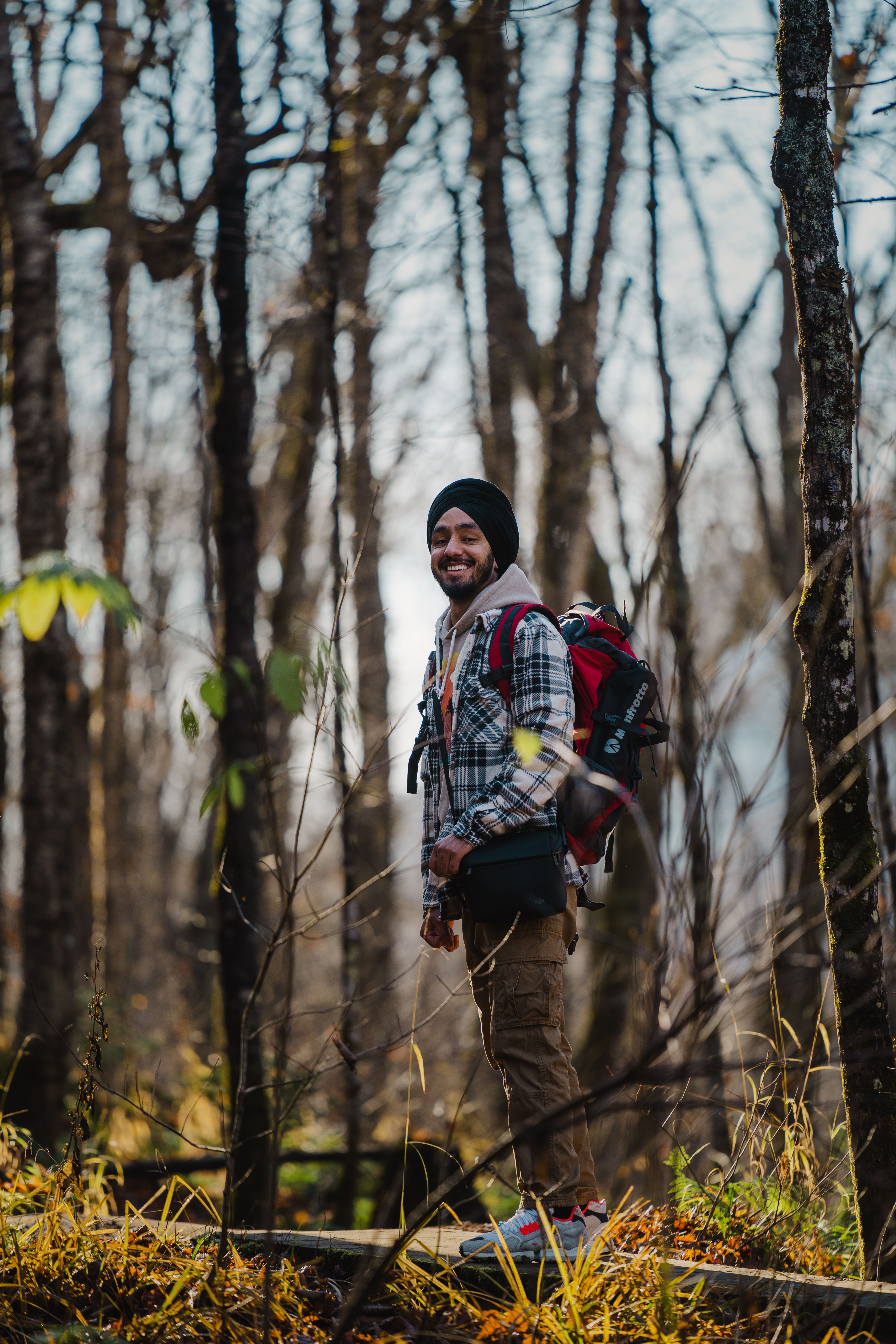 Young Man Hiking in Autumn Forest · Free Stock Photo