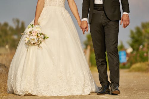 Woman Wearing White Wedding Dress And Man Wearing Black Suit