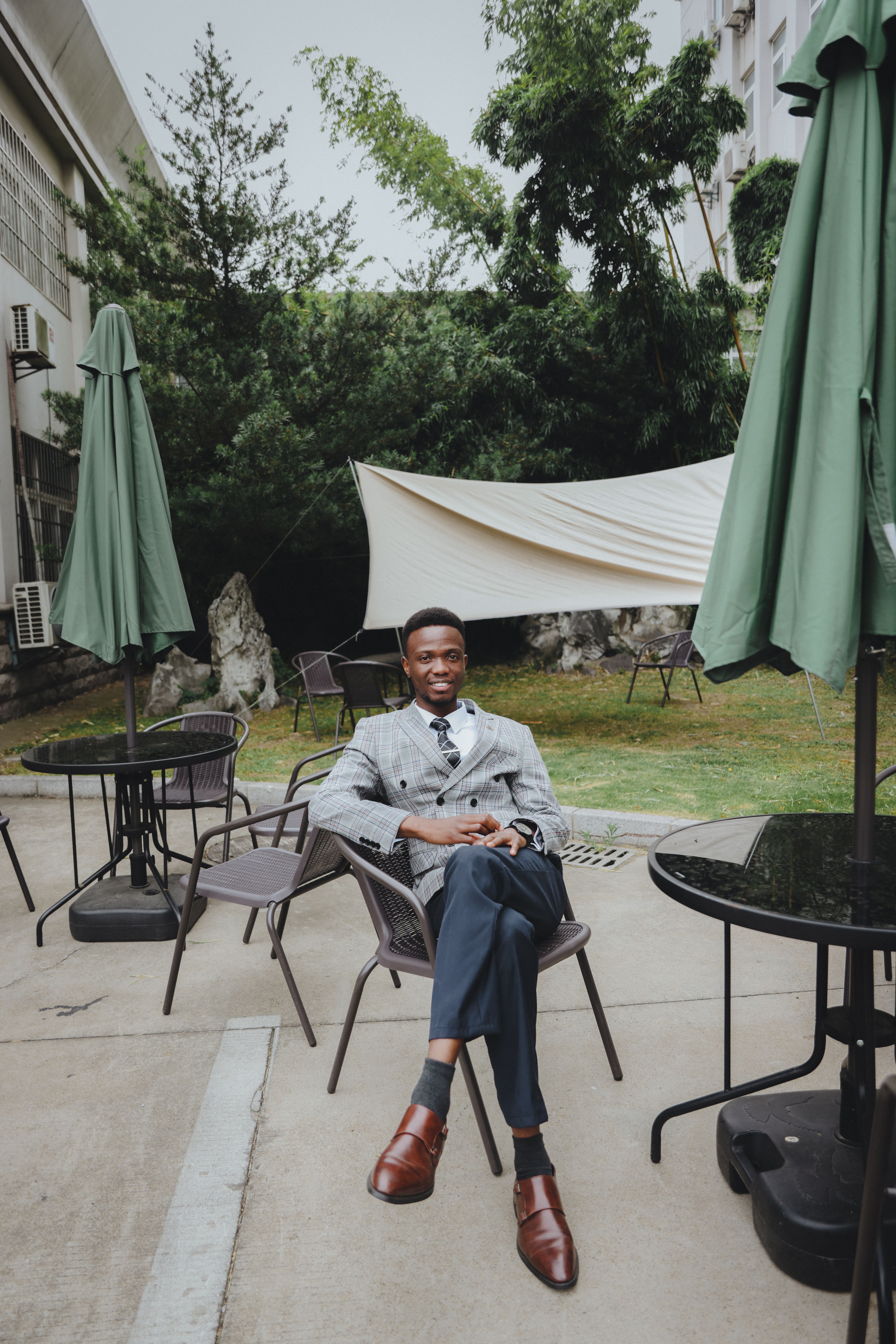 Stylish Man Relaxing in Outdoor Cafe Setting · Free Stock Photo