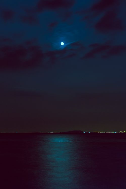 Free Calming moonlit scene over Lake Tai with reflections and clouds creating a tranquil night atmosphere. Stock Photo
