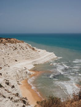 Breathtaking aerial view of Scala dei Turchi with white cliffs and turquoise sea in Sicily. by Manfredi Taglialavoro