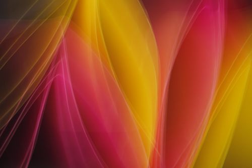 Free A dynamic abstract composition featuring vivid yellow and pink light trails. Stock Photo