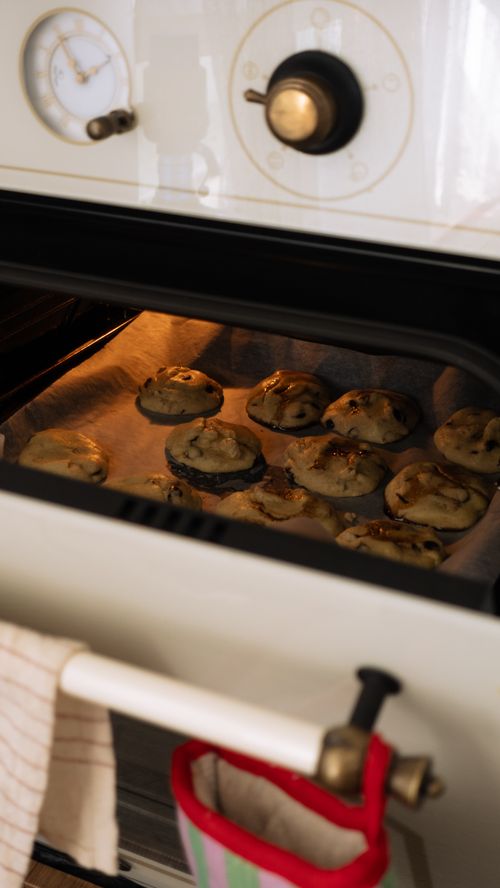 Warm cookies baking in a home oven — photo by Nursevim on Pexels