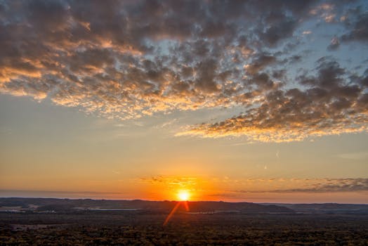 Breathtaking sunset view with dramatic clouds over Ella, Wisconsin, creating a serene and picturesque landscape.