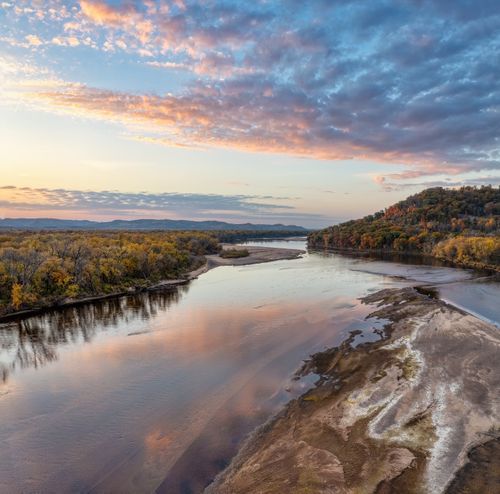 Free A stunning aerial view of the Mississippi River during a vibrant fall sunset in Ella, Wisconsin. Stock Photo