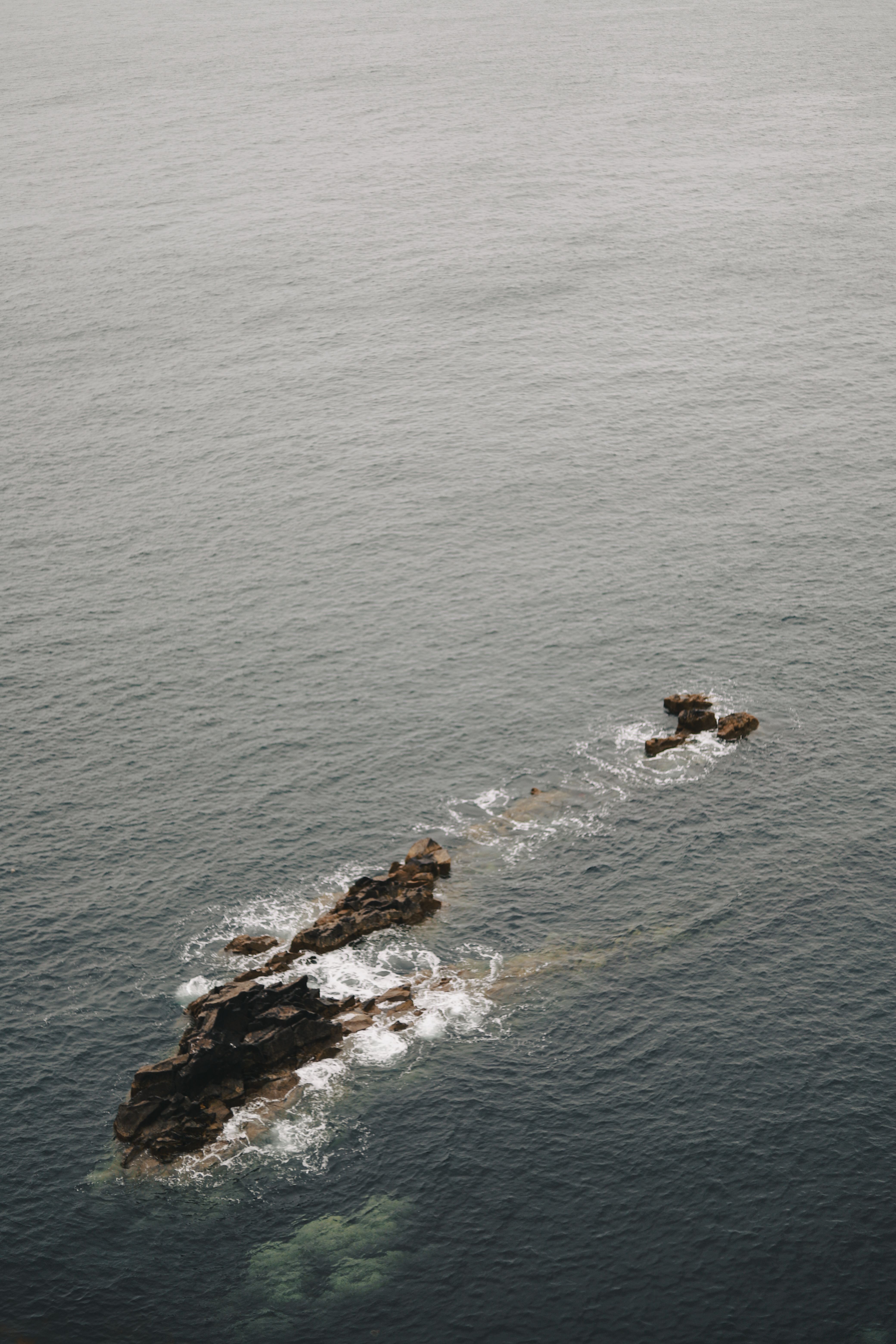 A tranquil view of a rocky outcrop along the coast of Scotland, United Kingdom.