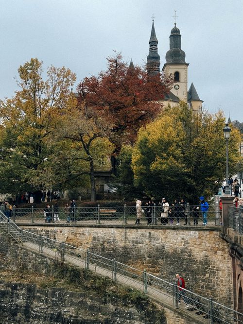 Free Picturesque autumn view of Notre-Dame Cathedral in Luxembourg City, with vibrant fall foliage and historic architecture. Stock Photo