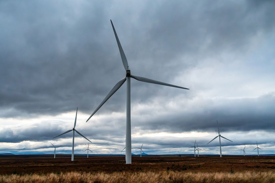 Vast wind farm with turbines harnessing wind energy under dramatic skies.