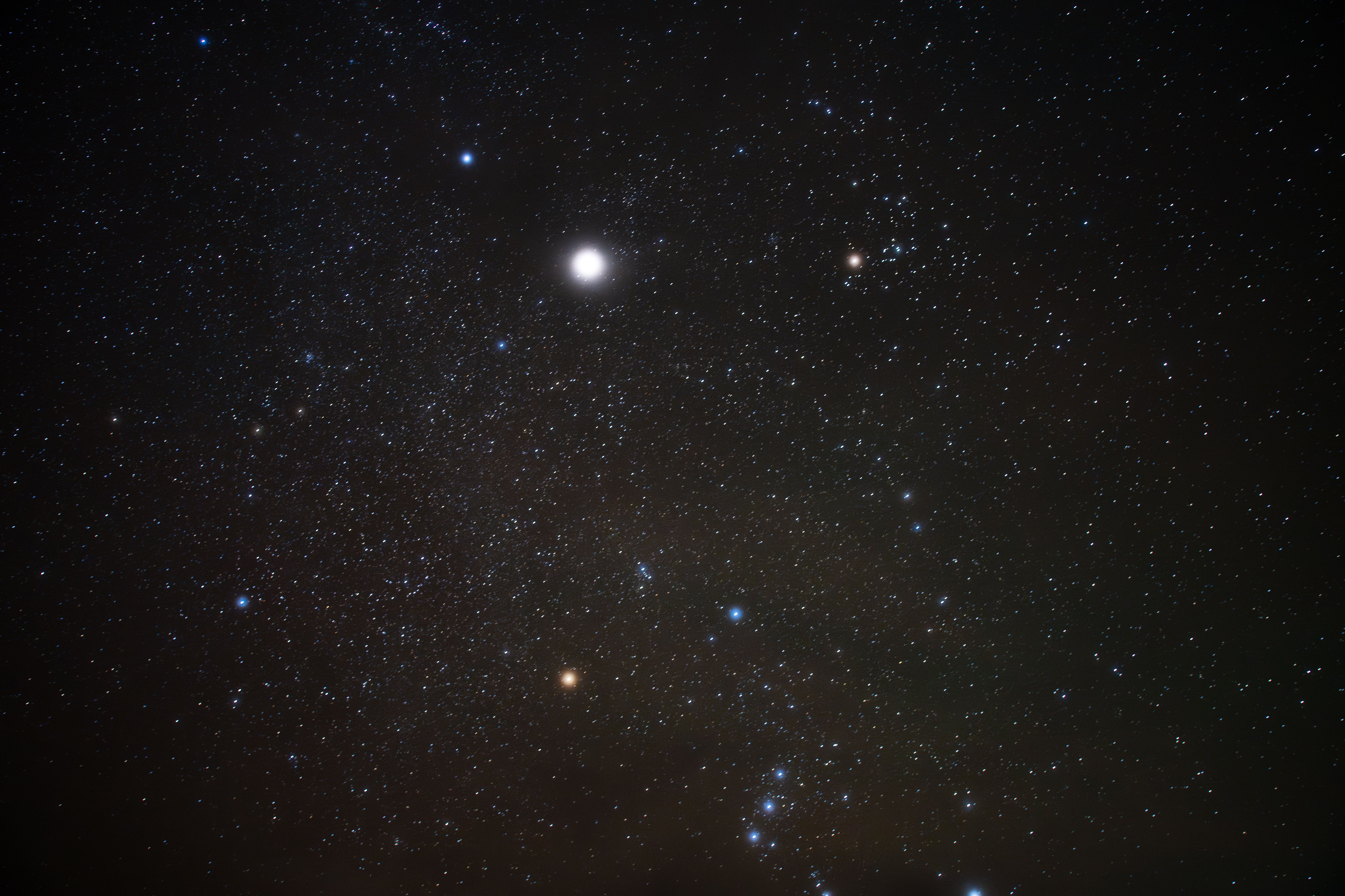 Bright stars in a clear night sky showcasing the Orion constellation and vibrant cosmic scene.