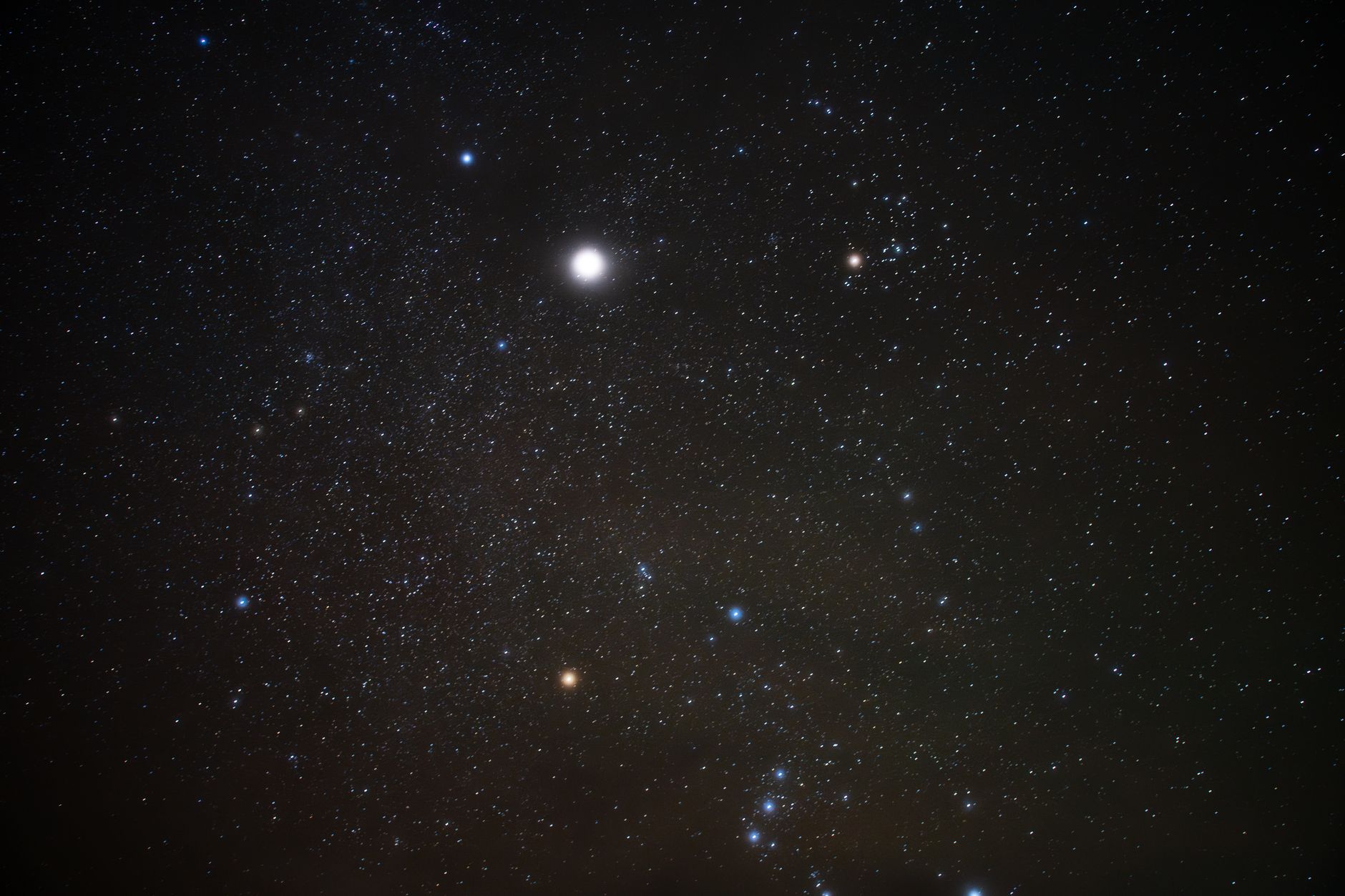 Bright stars in a clear night sky showcasing the Orion constellation and vibrant cosmic scene.