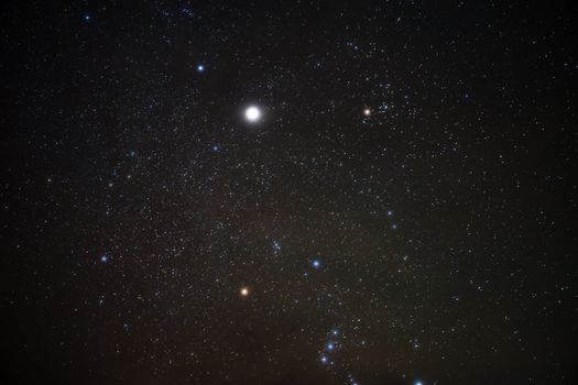 Bright stars in a clear night sky showcasing the Orion constellation and vibrant cosmic scene.