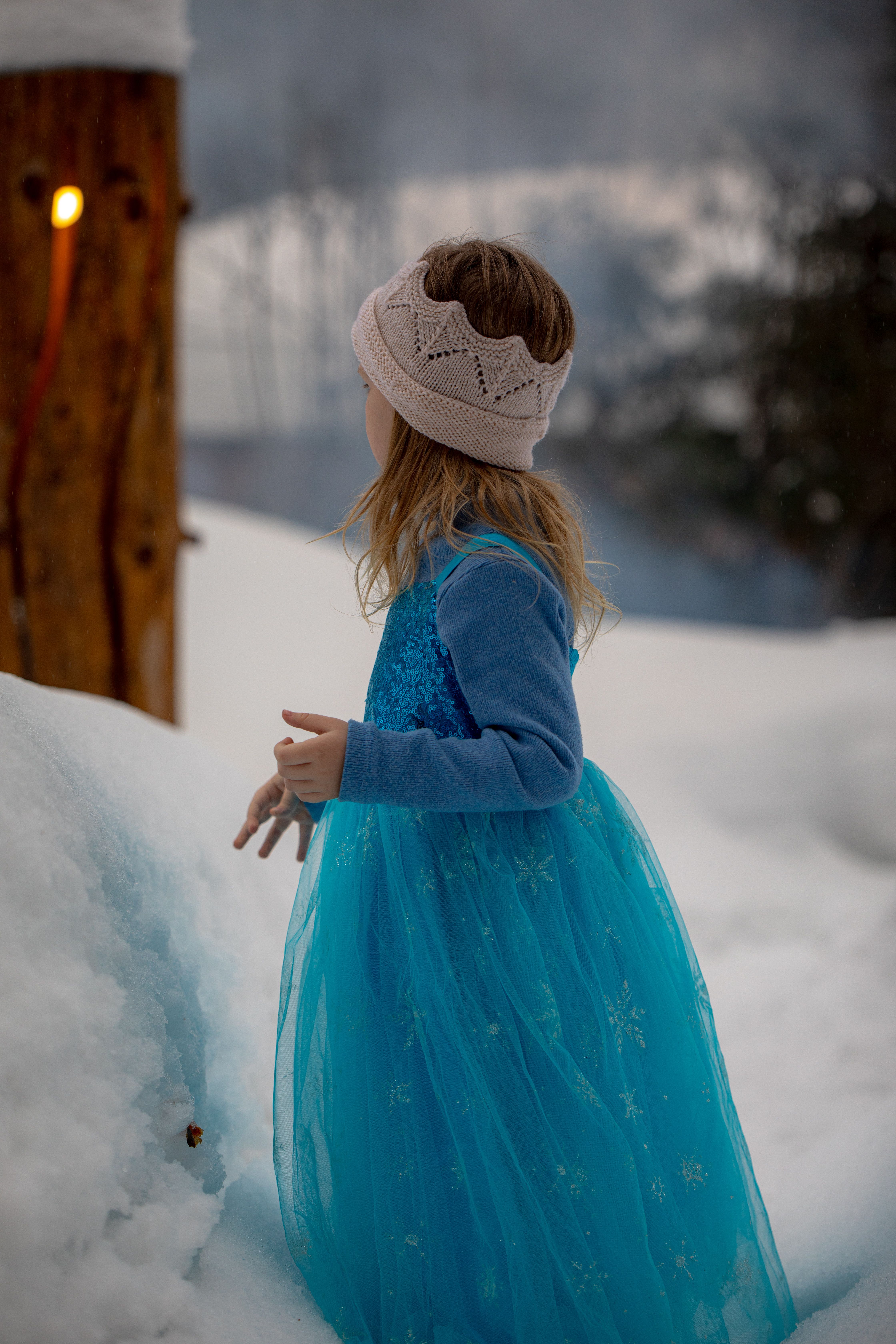 Little Girl in Blue Dress Playing in the Snow · Free Stock Photo