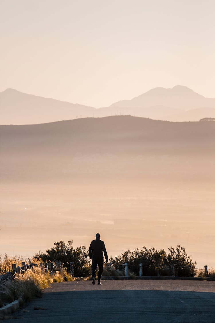 Person Walking On Road Viewing Mountain