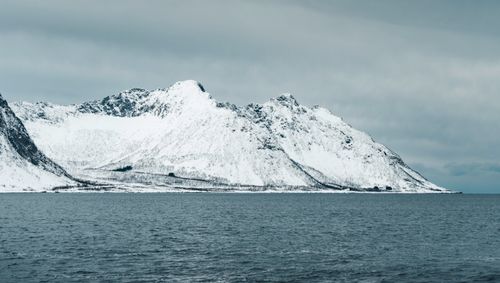 Free Captivating snow-covered mountains in Northern Norway by the Atlantic Ocean. Stock Photo