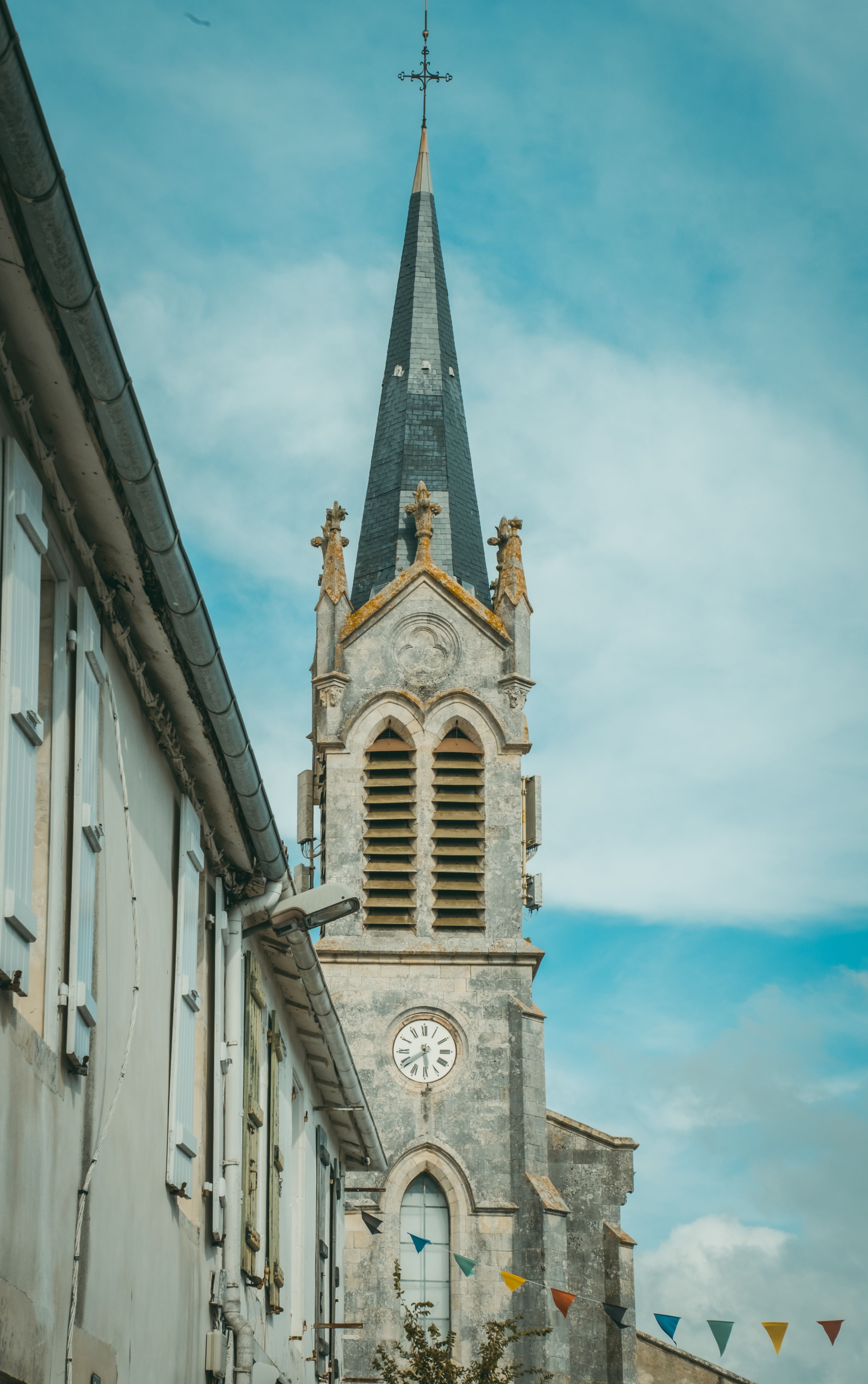 Historic Church Tower Against Blue Sky · Free Stock Photo