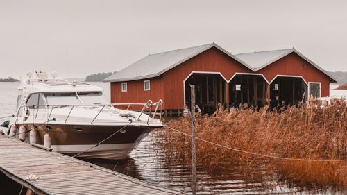 Free Elegant boat moored at red boat shed on Åland Islands during autumn. Stock Photo