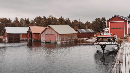 Free Rustic boat sheds and a rescue boat on a serene waterway in the Åland Islands, Finland. Stock Photo