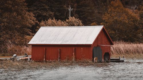 Free Rustic red boat shed by lake in autumn, Åland Islands, Finland. Stock Photo