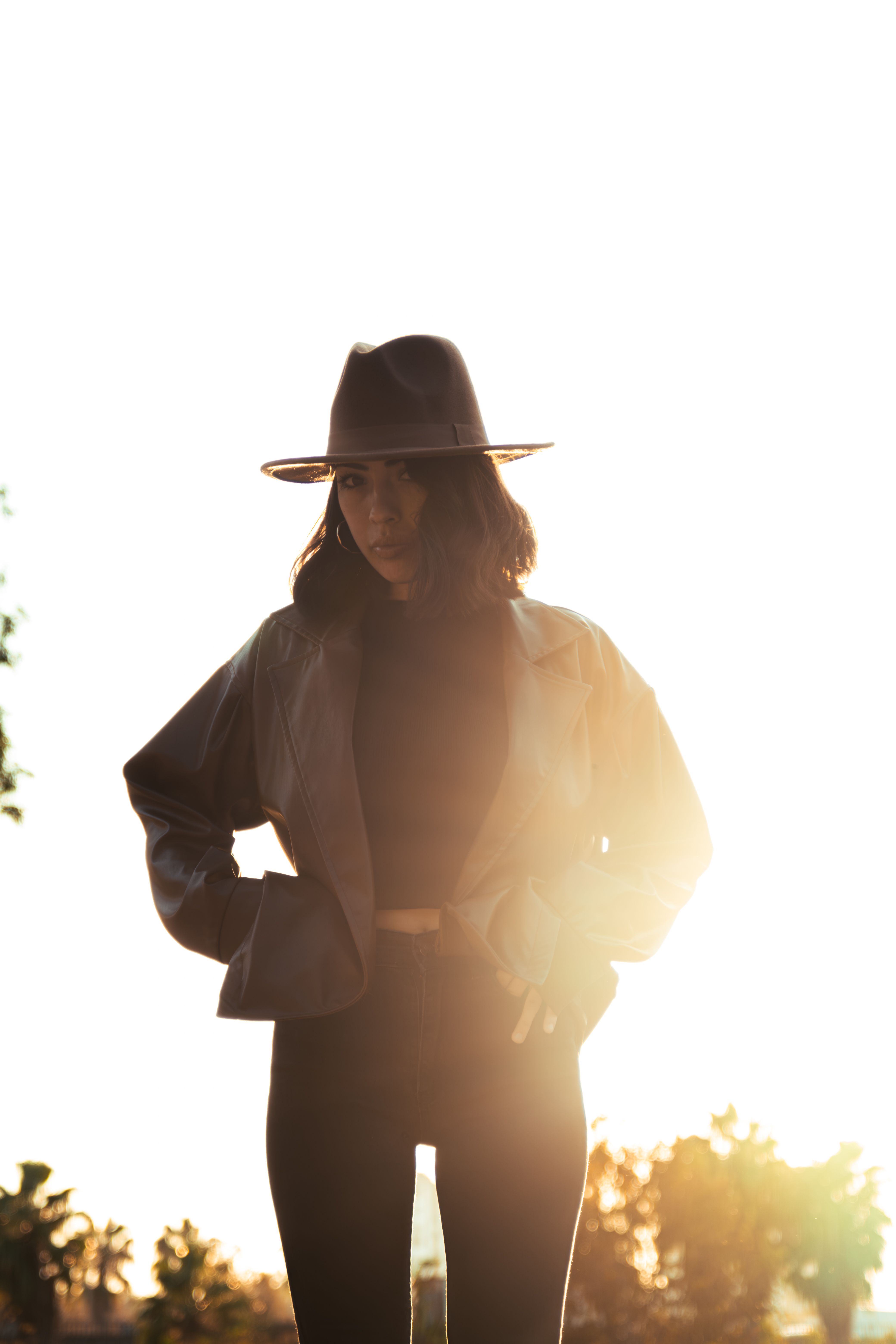 Stylish Woman Posing Outdoors at Sunset · Free Stock Photo