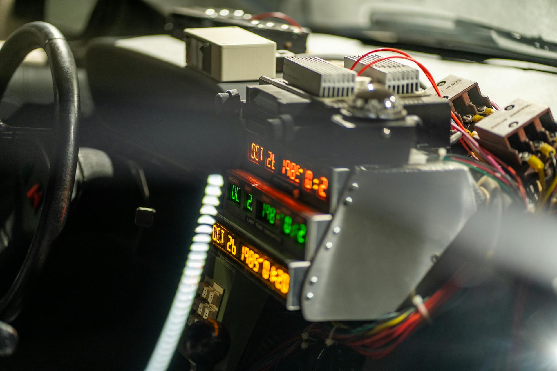 Intricate dashboard featuring digital displays and wiring, suggesting a high-tech or futuristic vehicle interior.