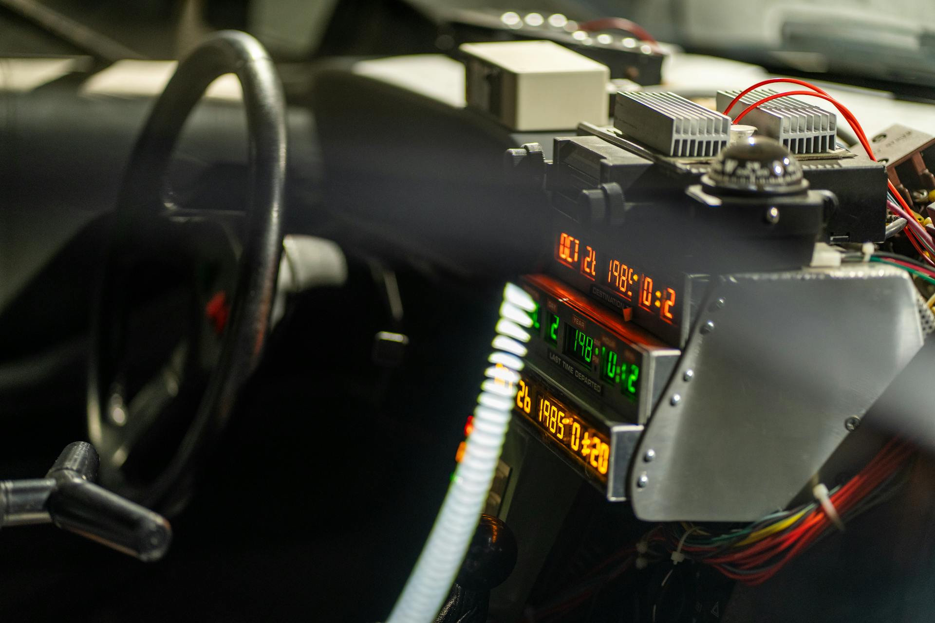 Close-up of a futuristic car dashboard filled with electronic gadgets and glowing displays.