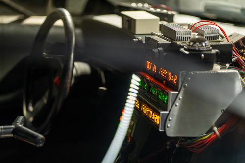Free Close-up of a futuristic car dashboard filled with electronic gadgets and glowing displays. Stock Photo
