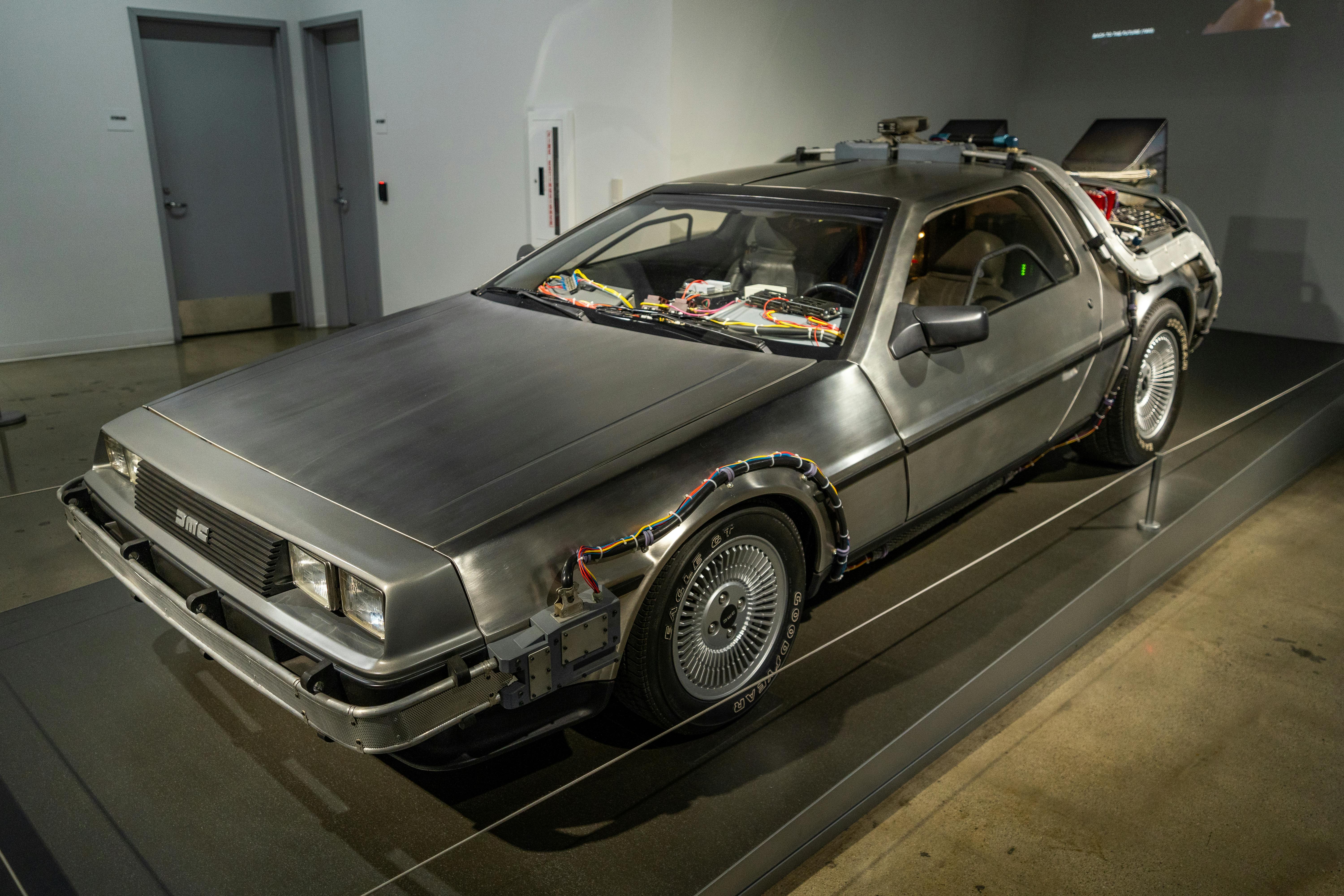 Classic DeLorean car displayed in a museum, showcasing unique retro design and features.